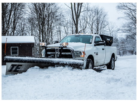 Snow Dogg plow on a white Dodge truck